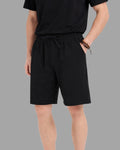 man wearing black cotton sweat shorts with draw string waist and deep pockets
