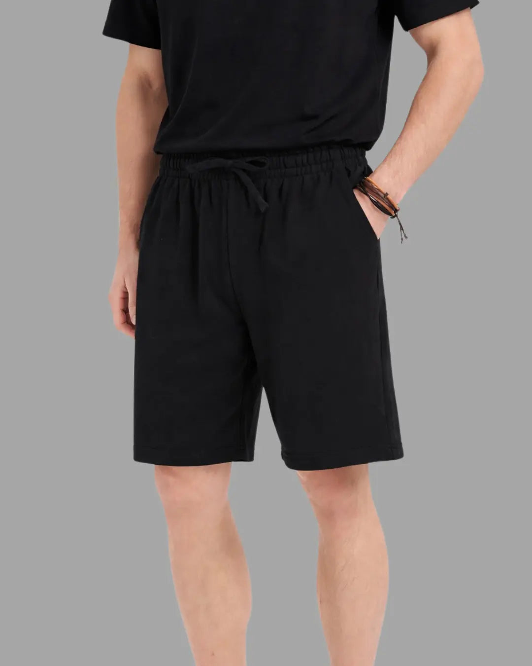 man wearing black cotton sweat shorts with draw string waist and deep pockets